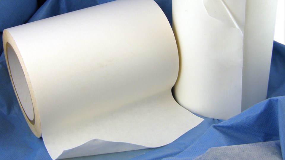 Rolls of medical pressure sensitive adhesive tape on blue medical cloth