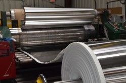 A roll of metal in a factory

AI-generated content may be incorrect.