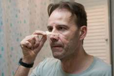 Applying Nasal Strips on Bridge of Nose
