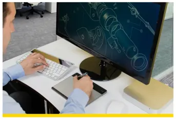 Man at computer with schematic on screen